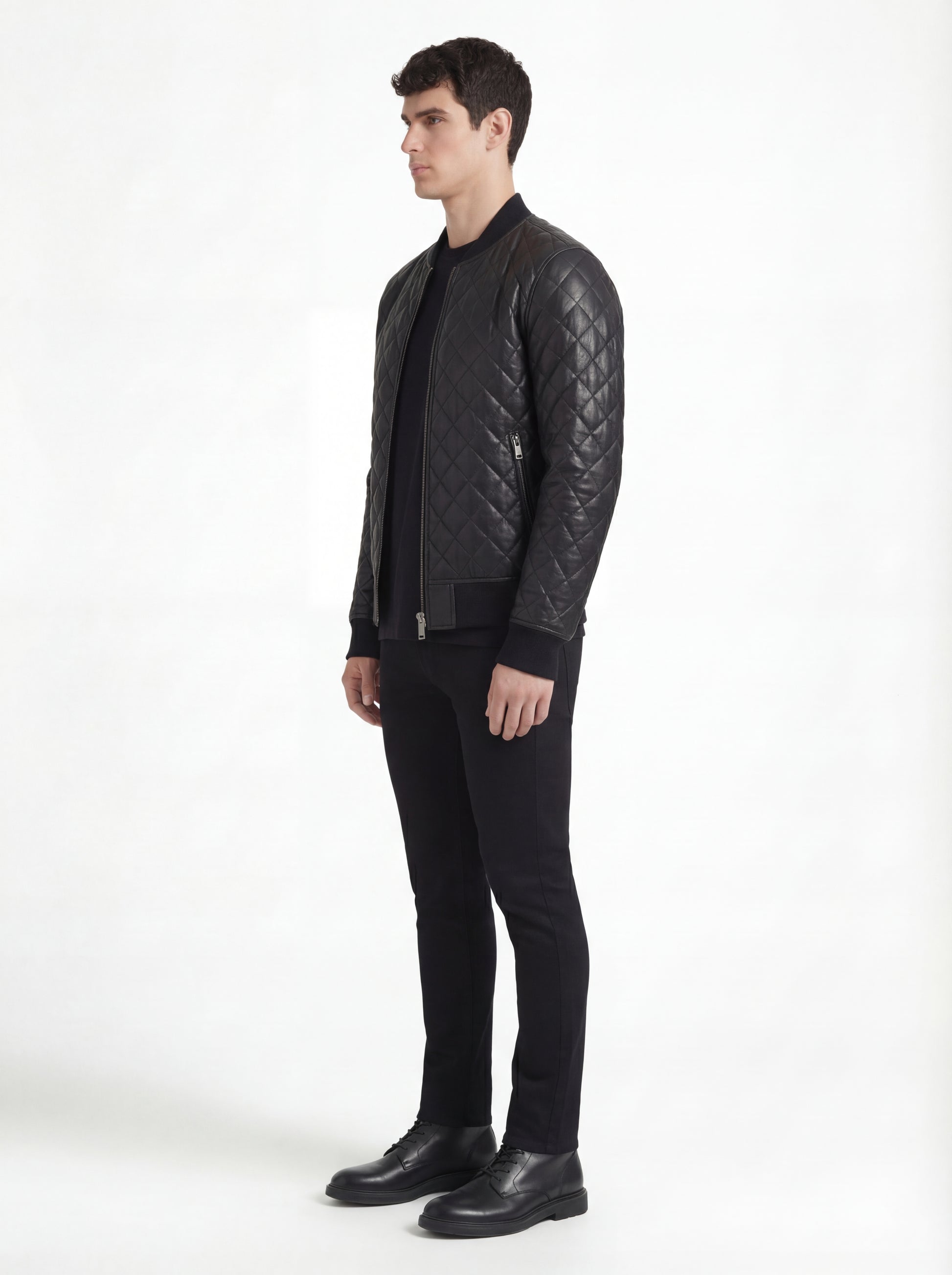 Side profile of Maverick Nero quilted bomber jacket showing diamond quilted sleeve design and slim torso silhouette. Maverick Jacket.