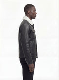 Side profile of Maverick Corbin leather jacket showing button cuff detail and straight silhouette. Maverick Jacket.