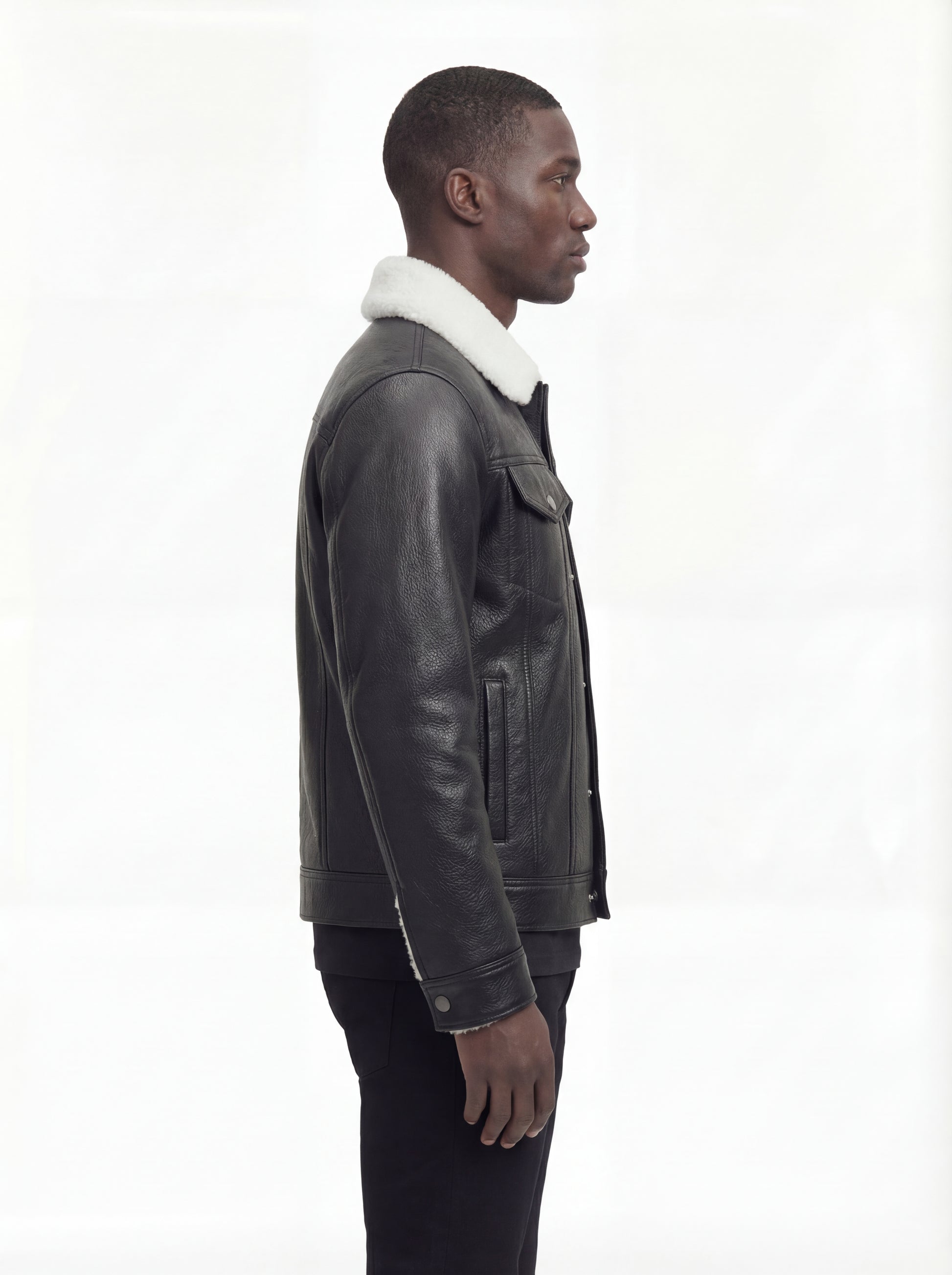 Side profile of Maverick Corbin leather jacket showing button cuff detail and straight silhouette. Maverick Jacket.