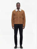 Male model wearing Maverick Caden suede shearling jacket, regular fit, styled with black slim-fit trousers and black leather shoes. Maverick Jacket.
