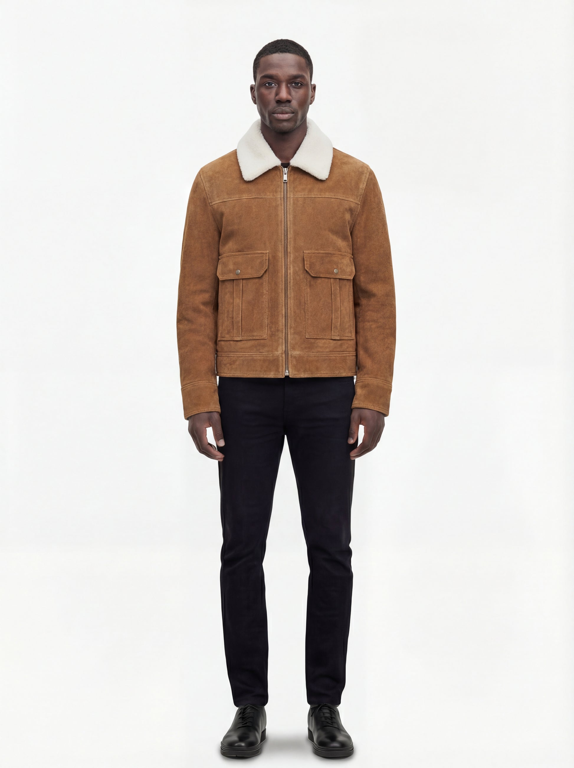 Male model wearing Maverick Caden suede shearling jacket, regular fit, styled with black slim-fit trousers and black leather shoes. Maverick Jacket.