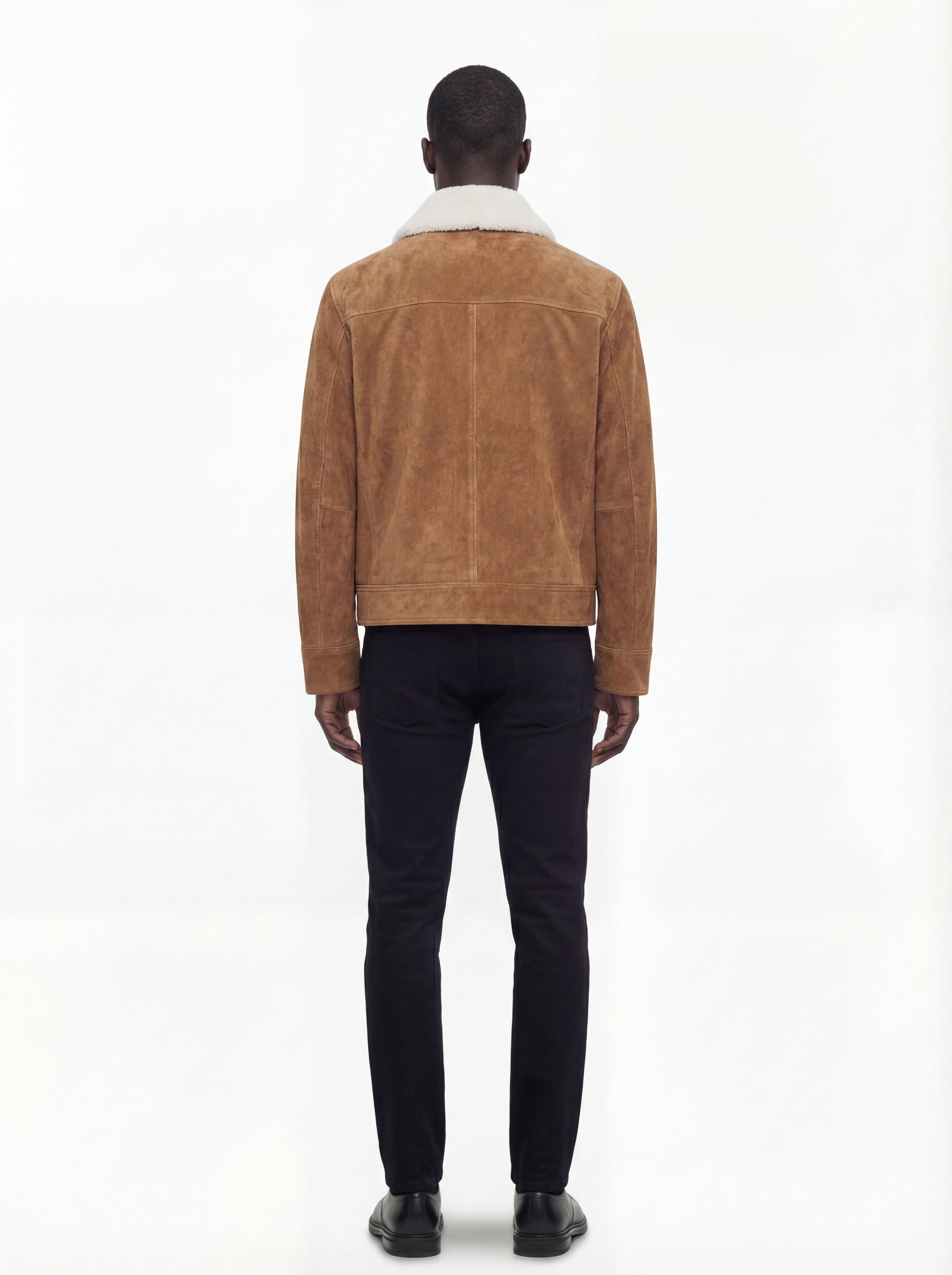 Rear view of male model wearing Maverick Caden suede shearling jacket showing broad shoulder fit and clean back paneling. Maverick Jacket.
