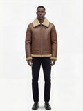 Male model wearing Maverick Sterling shearling aviator jacket, regular fit, styled with black crewneck t-shirt and black slim-fit jeans. Maverick Jacket.