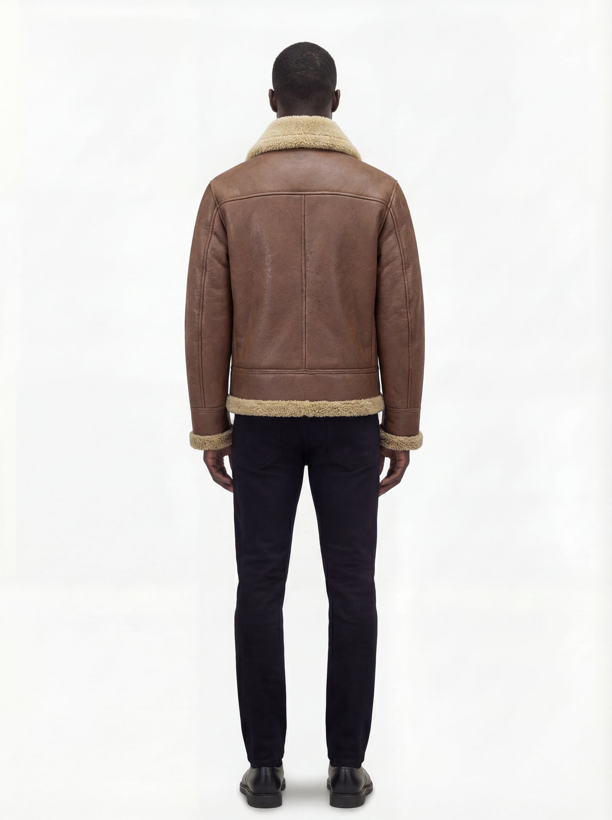 Rear view of male model wearing Maverick Sterling shearling aviator jacket showing structured shoulder fit and shearling-trimmed hem. Maverick Jacket.