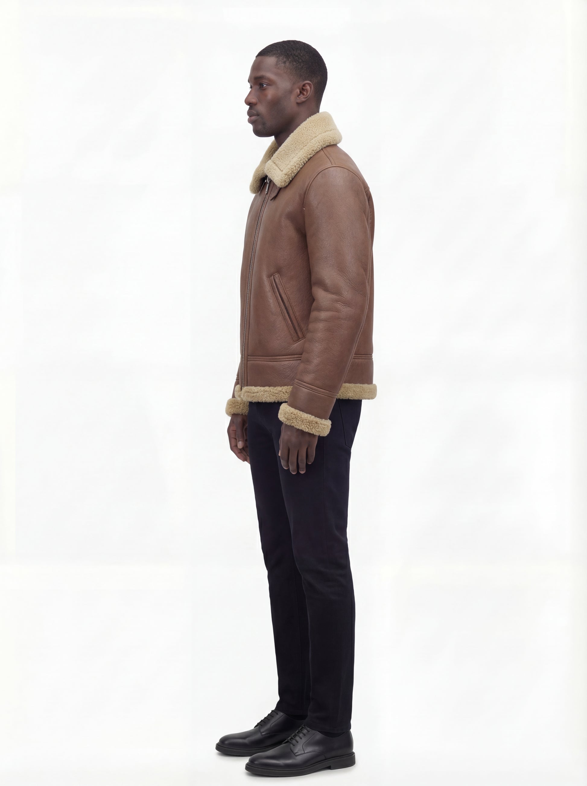 Side profile of Maverick Sterling shearling aviator jacket showing slanted zipper pocket and straight silhouette. Maverick Jacket.