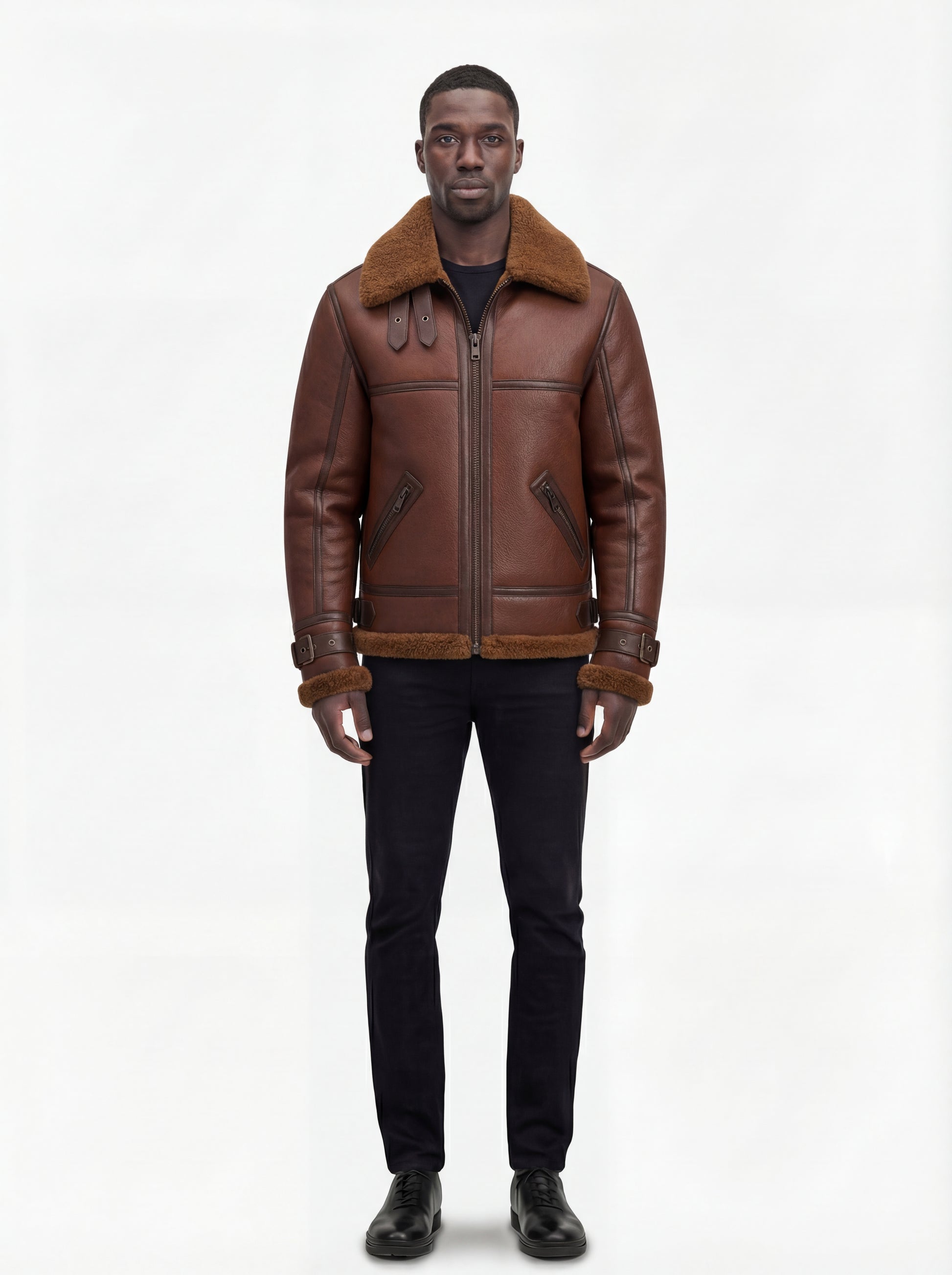 Male model wearing Maverick Sol B3 shearling bomber jacket, regular fit, styled with black slim-fit jeans and black leather shoes. Maverick Jacket.