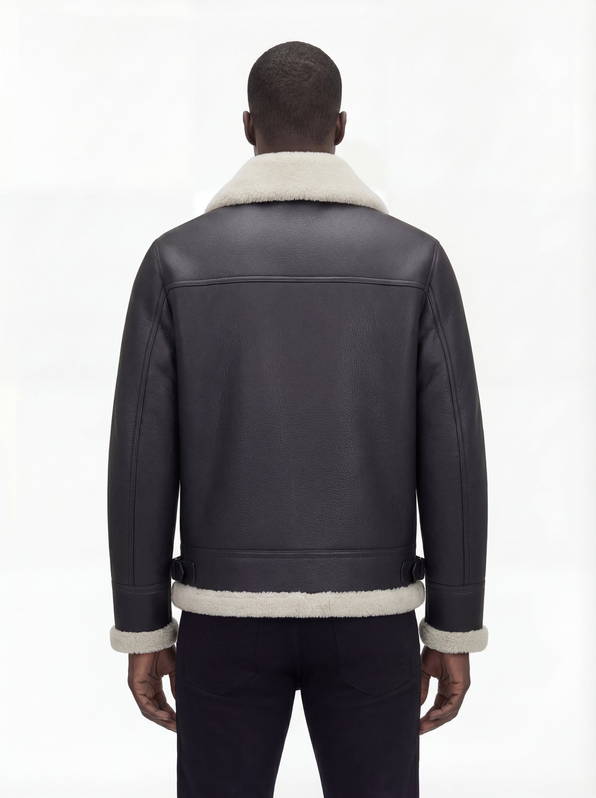 Rear view of male model wearing Maverick Ronan shearling B3 bomber jacket showing broad shoulder fit and shearling-trimmed hem. Maverick Jacket.