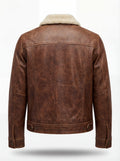 Rear view of Distressed Brown Leather Trucker Jacket showing vertical back seams and adjustable waist button tabs. The Wyatt by Maverick Jacket.