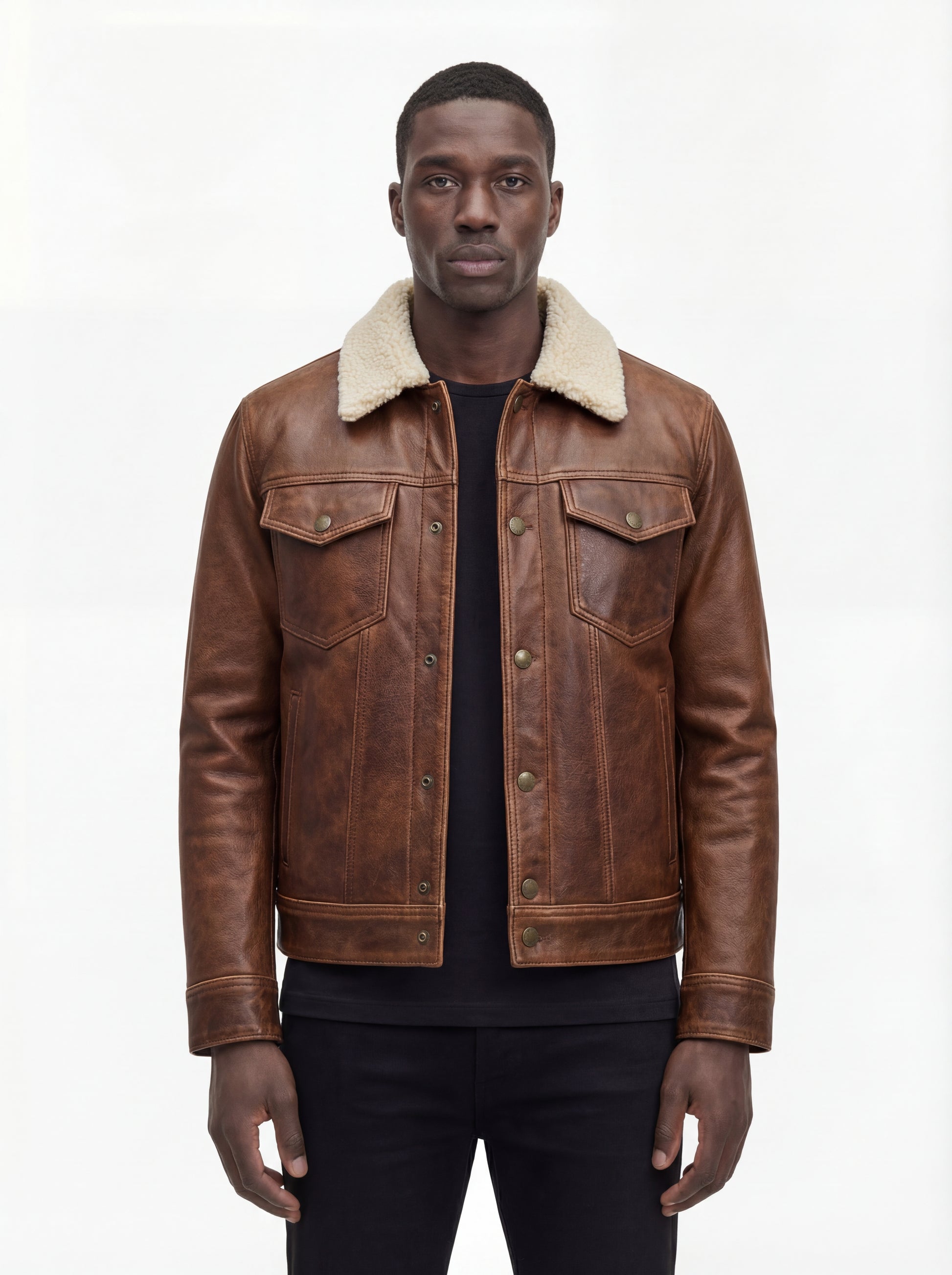 Male model wearing Maverick Wyatt leather trucker jacket, regular fit, styled with black crewneck t-shirt and black slim-fit jeans. Maverick Jacket.