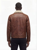 Rear view of male model wearing Maverick Wyatt leather trucker jacket showing structured shoulder fit and adjustable hem styling. Maverick Jacket.