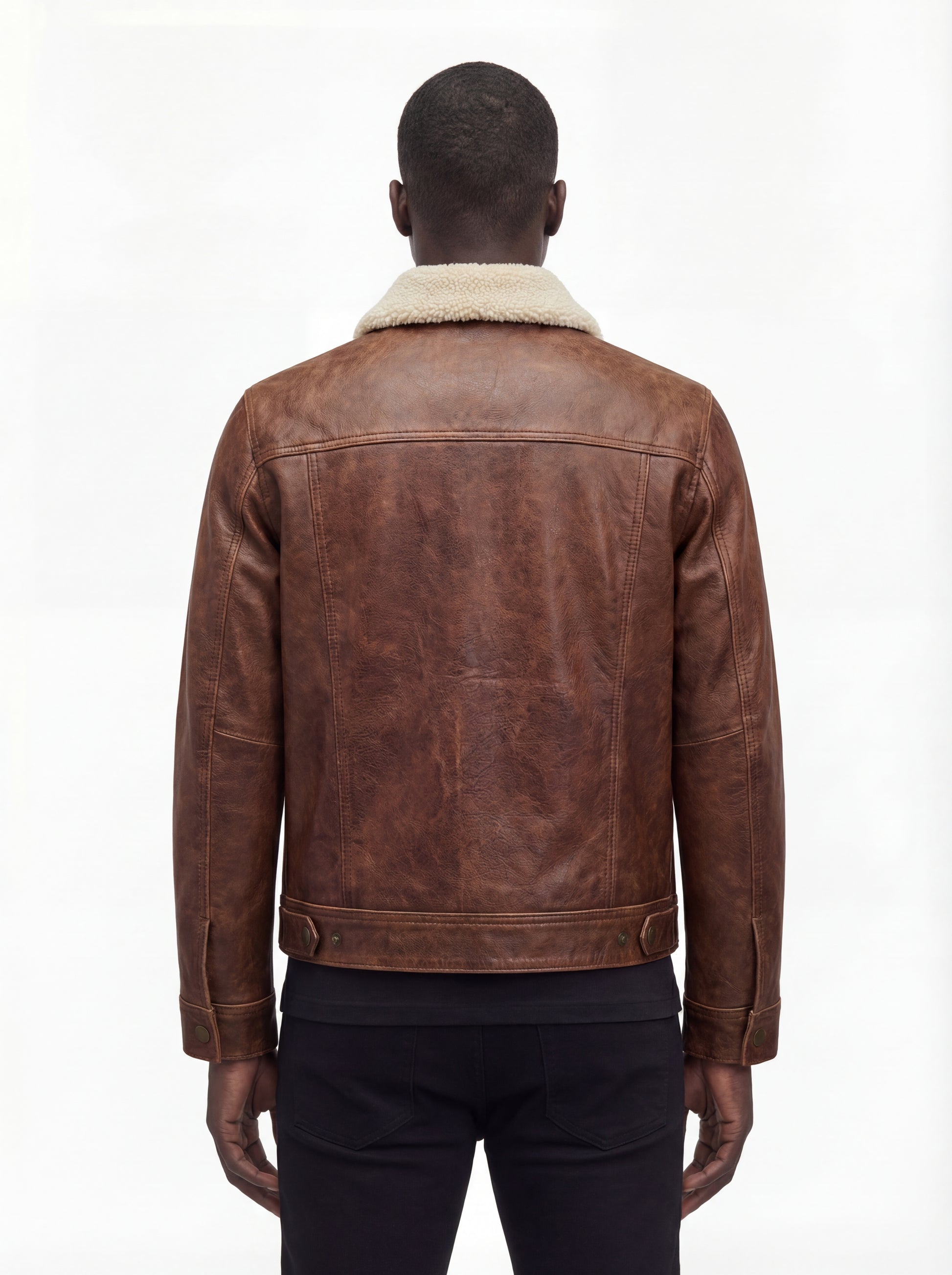 Rear view of male model wearing Maverick Wyatt leather trucker jacket showing structured shoulder fit and adjustable hem styling. Maverick Jacket.