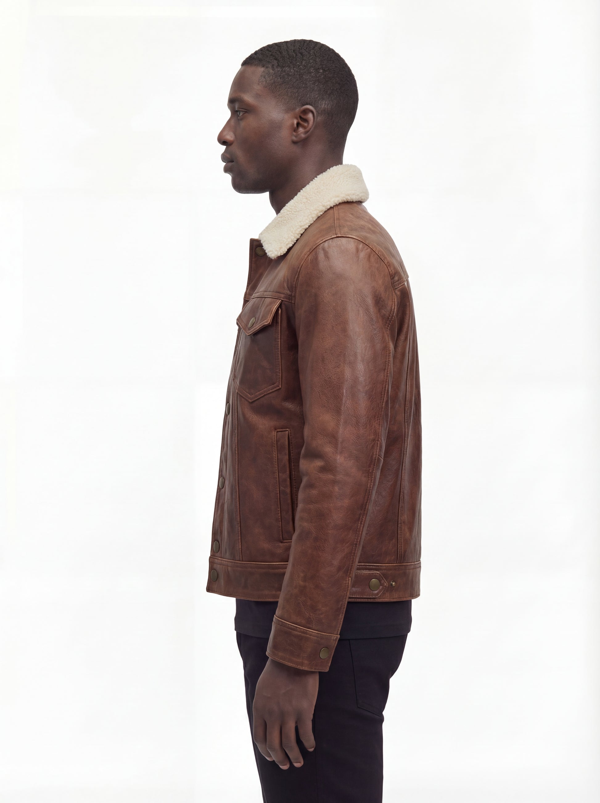 Side profile of Maverick Wyatt leather trucker jacket showing button cuff detail and straight silhouette. Maverick Jacket.