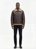 Male model wearing Maverick Beckett shearling aviator jacket, regular fit, styled with black slim-fit jeans and black leather shoes. Maverick Jacket.