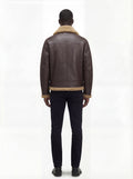 Rear view of male model wearing Maverick Beckett shearling aviator jacket showing structured shoulder fit and shearling-trimmed hem. Maverick Jacket.