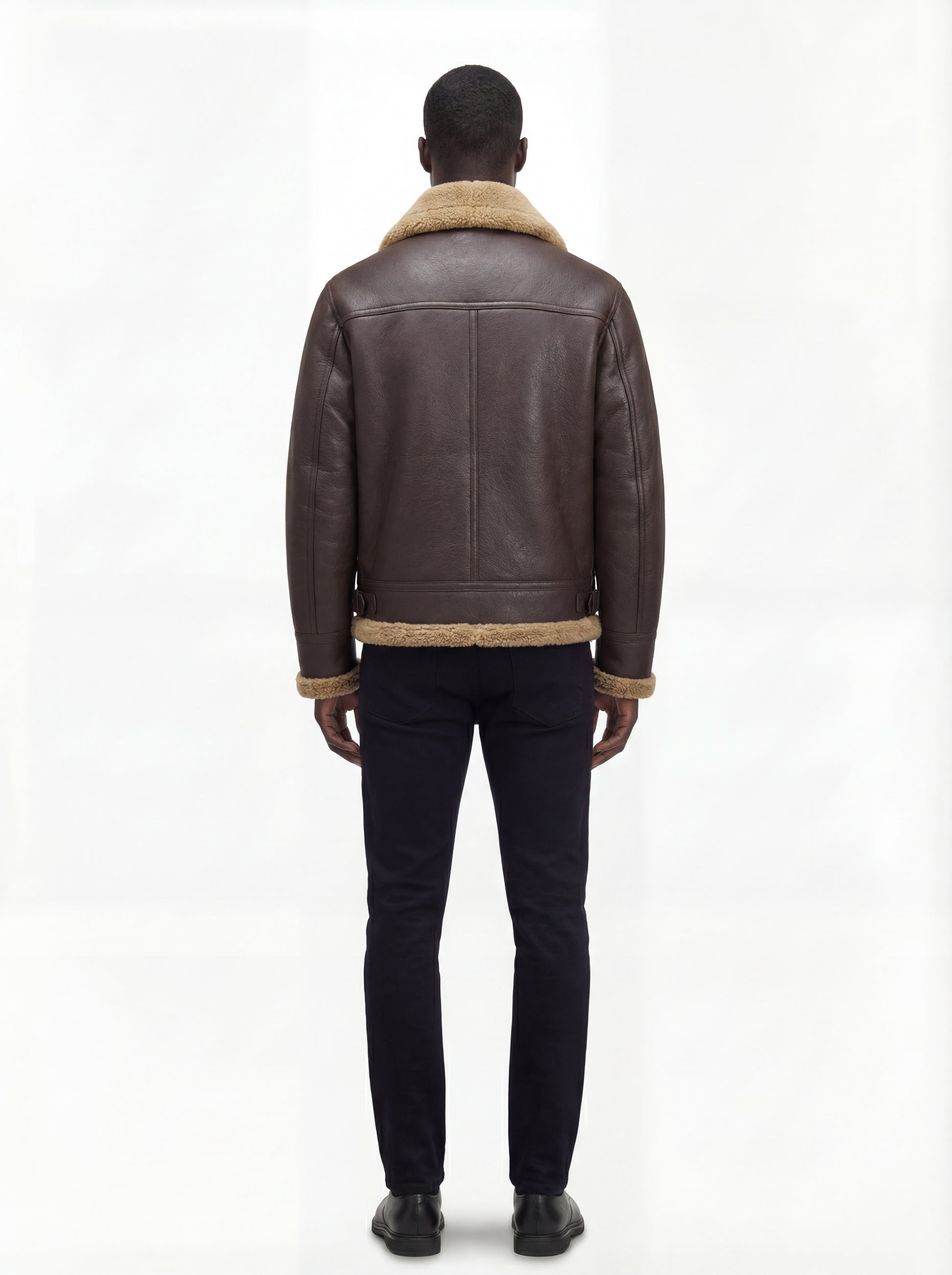 Rear view of male model wearing Maverick Beckett shearling aviator jacket showing structured shoulder fit and shearling-trimmed hem. Maverick Jacket.