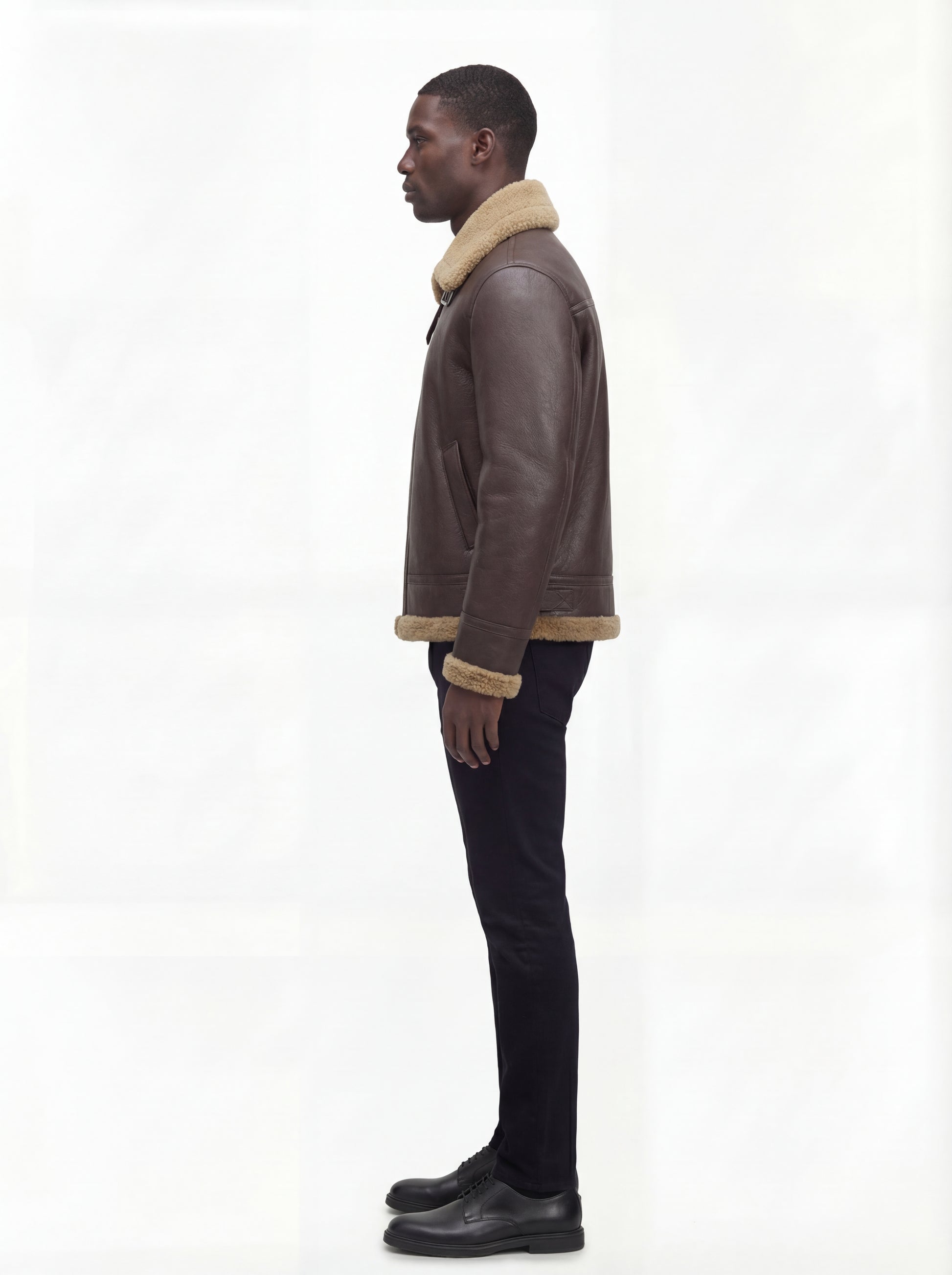 Side profile of Maverick Beckett shearling aviator jacket showing shearling cuff detail and straight silhouette. Maverick Jacket.