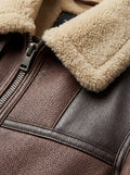 Macro shot of pebbled brown leather texture and thick cream shearling collar on aviator jacket. The Hayes by Maverick Jacket.