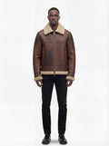 Male model wearing Maverick Hayes shearling aviator jacket, regular fit, styled with black slim-fit jeans and black leather shoes. Maverick Jacket.