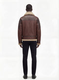 Rear view of male model wearing Maverick Hayes shearling aviator jacket showing broad shoulder fit and shearling-trimmed hem styling. Maverick Jacket.