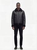 Male model wearing Maverick Zane shearling jacket, regular fit, styled with black crewneck t-shirt and black slim-fit trousers. Maverick Jacket.