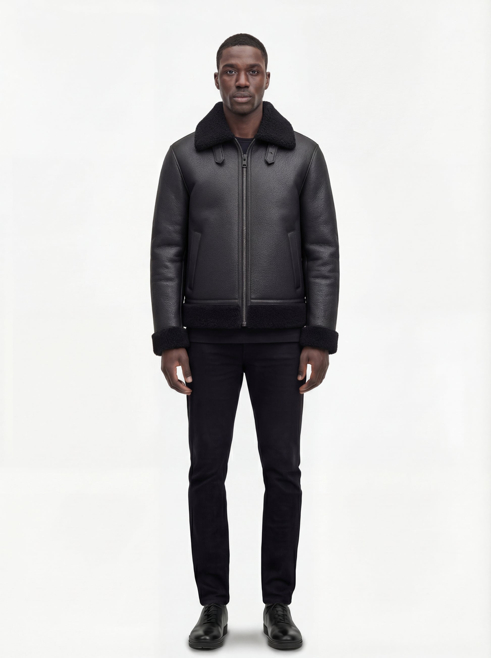 Male model wearing Maverick Zane shearling jacket, regular fit, styled with black crewneck t-shirt and black slim-fit trousers. Maverick Jacket.