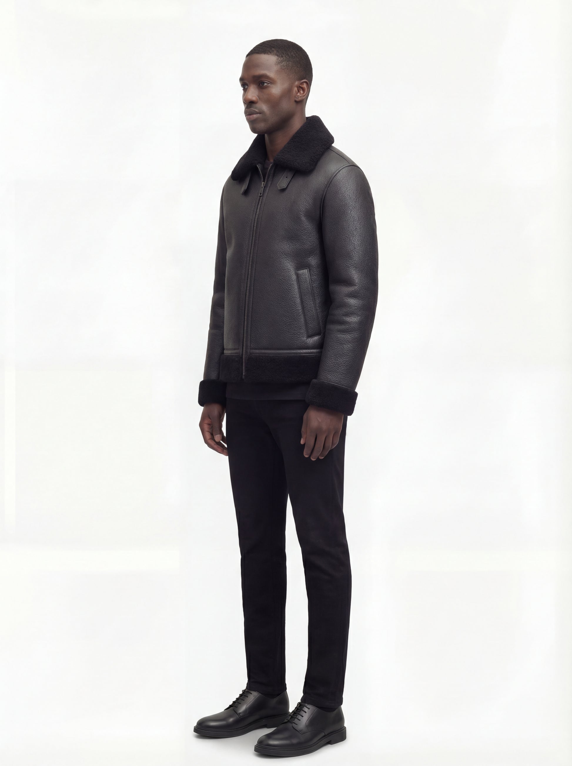 Side profile of Maverick Zane shearling jacket showing shearling cuff detail and straight silhouette. Maverick Jacket.