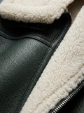 Macro shot of pebbled forest green leather texture and thick white shearling collar on aviator jacket. The Lorcan by Maverick Jacket.