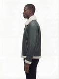 Side profile of Maverick Lorcan shearling aviator jacket showing zippered sleeve pocket and shearling cuff. Maverick Jacket.