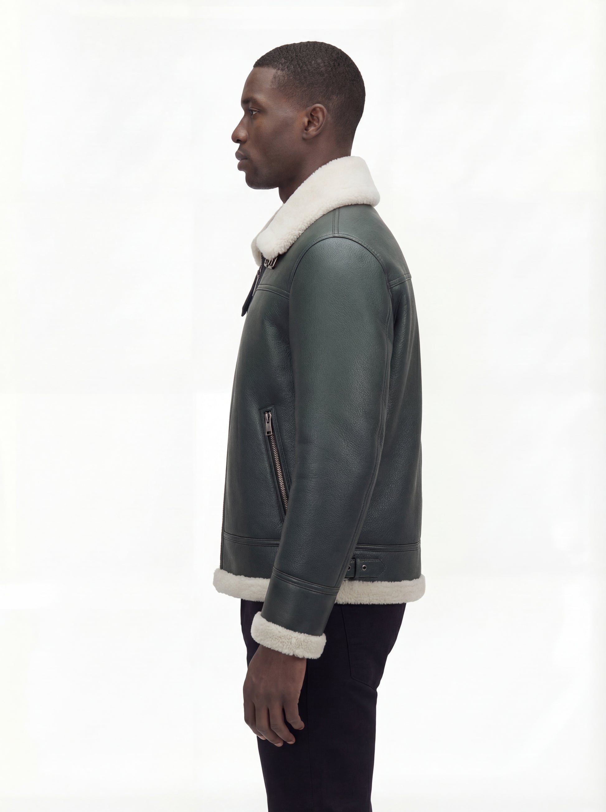 Side profile of Maverick Lorcan shearling aviator jacket showing zippered sleeve pocket and shearling cuff. Maverick Jacket.