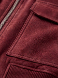 Macro shot of soft red suede texture and pocket stitching detail on bomber jacket. The Rory by Maverick Jacket.