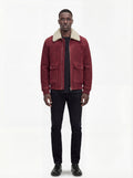 Male model wearing Maverick Rory suede bomber jacket, regular fit, styled with black crewneck t-shirt and black slim-fit jeans. Maverick Jacket.