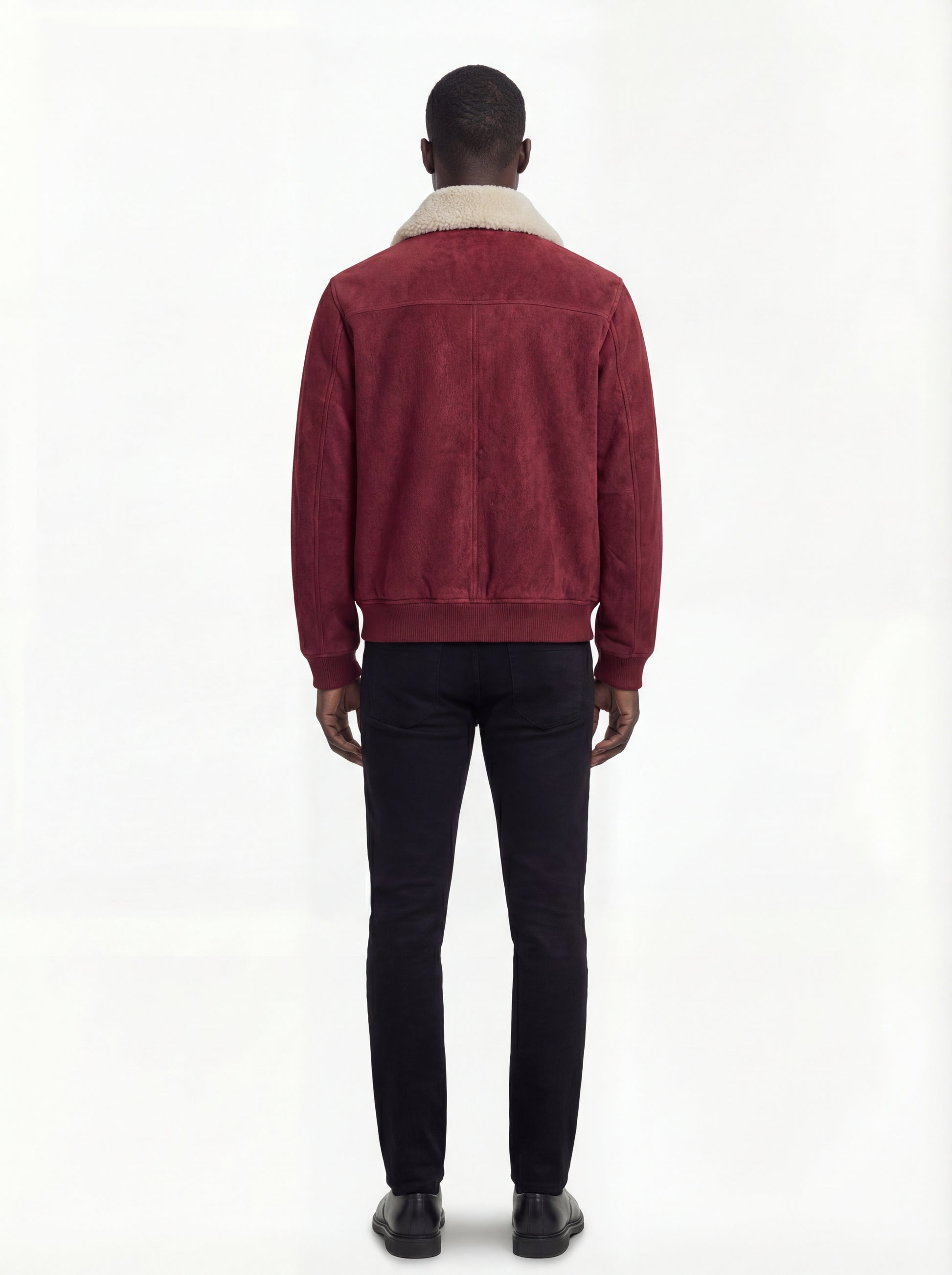Rear view of male model wearing Maverick Rory suede bomber jacket showing structured shoulder fit and clean back paneling. Maverick Jacket.