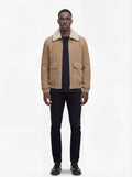 Male model wearing Maverick Finn suede bomber jacket, regular fit, styled with black crewneck t-shirt and black slim-fit trousers. Maverick Jacket.