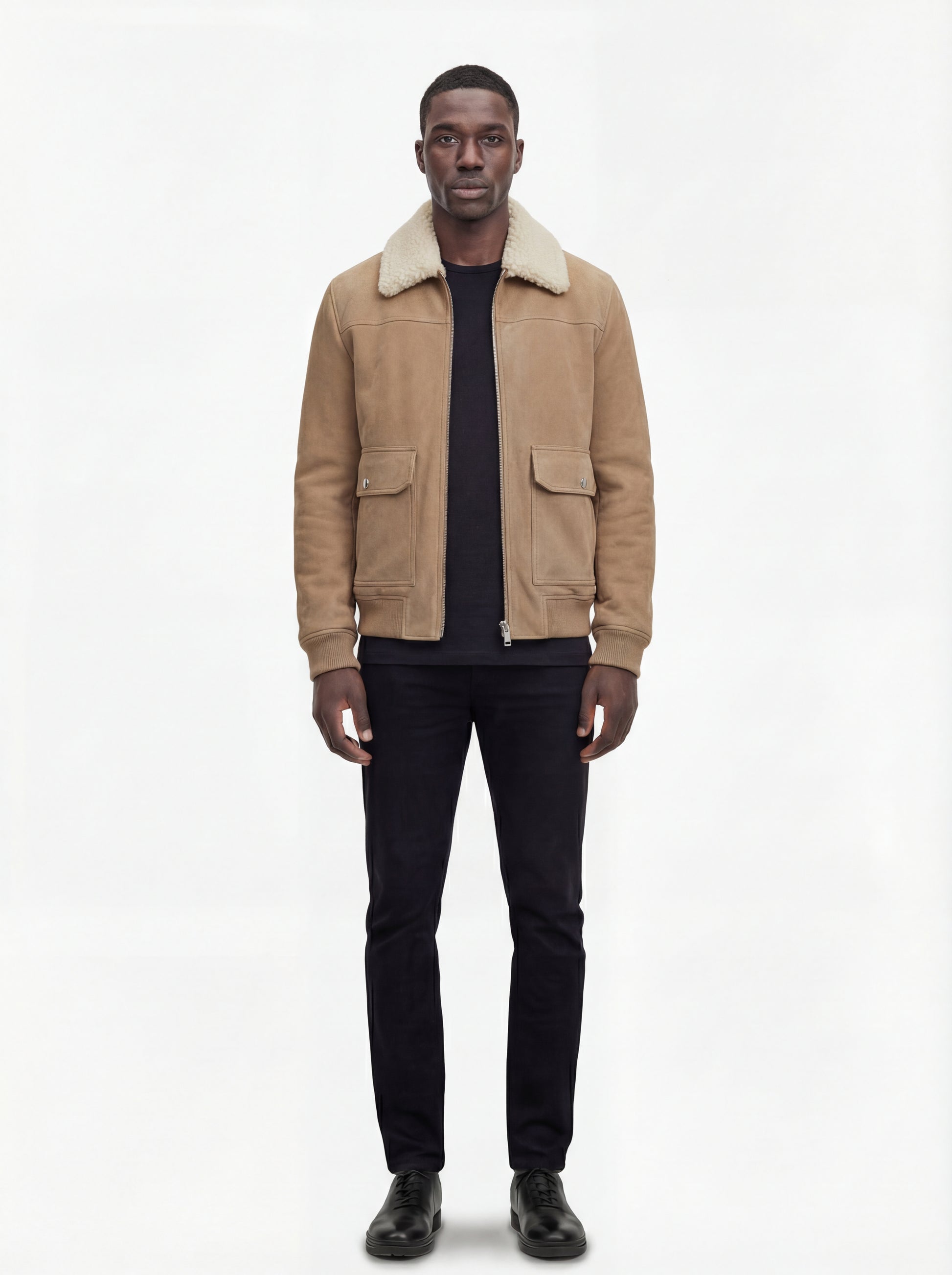 Male model wearing Maverick Finn suede bomber jacket, regular fit, styled with black crewneck t-shirt and black slim-fit trousers. Maverick Jacket.