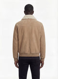 Rear view of male model wearing Maverick Finn suede bomber jacket showing structured shoulder fit and ribbed hem styling. Maverick Jacket.