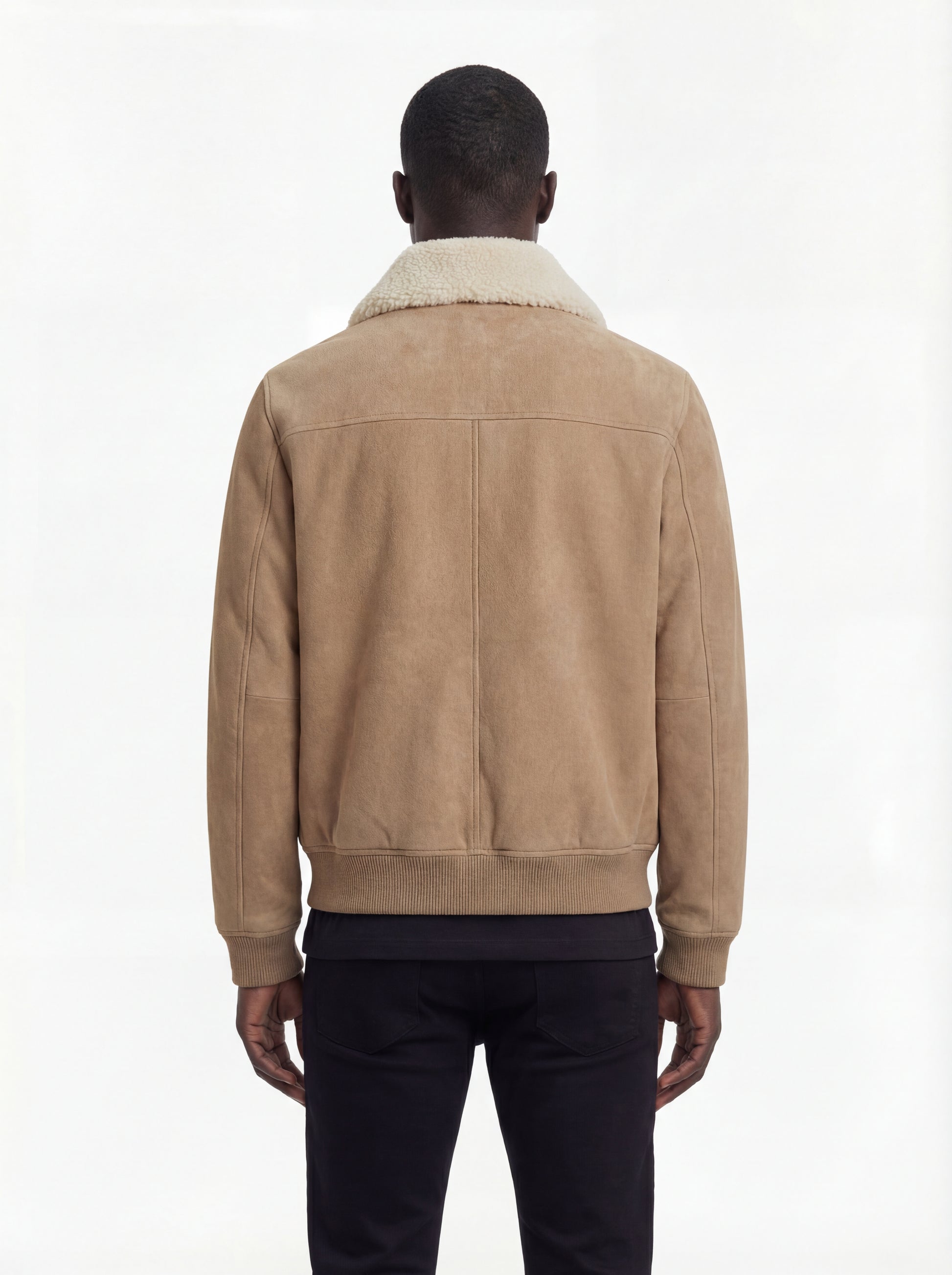 Rear view of male model wearing Maverick Finn suede bomber jacket showing structured shoulder fit and ribbed hem styling. Maverick Jacket.