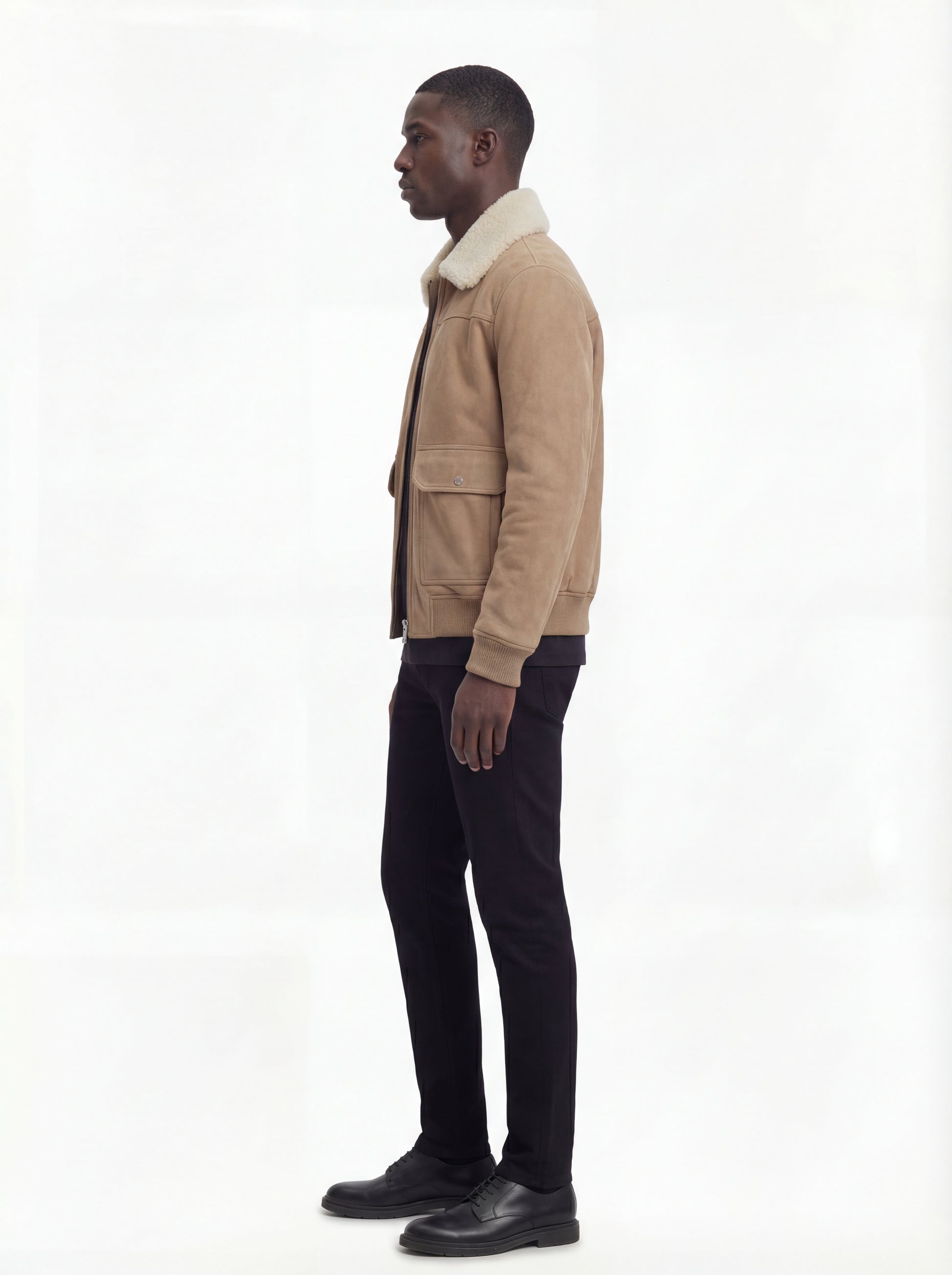 Side profile of Maverick Finn bomber jacket showing ribbed cuff detail and straight silhouette. Maverick Jacket.