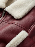 Macro shot of pebbled burgundy leather texture and thick white shearling collar on aviator jacket. The Cormac by Maverick Jacket.