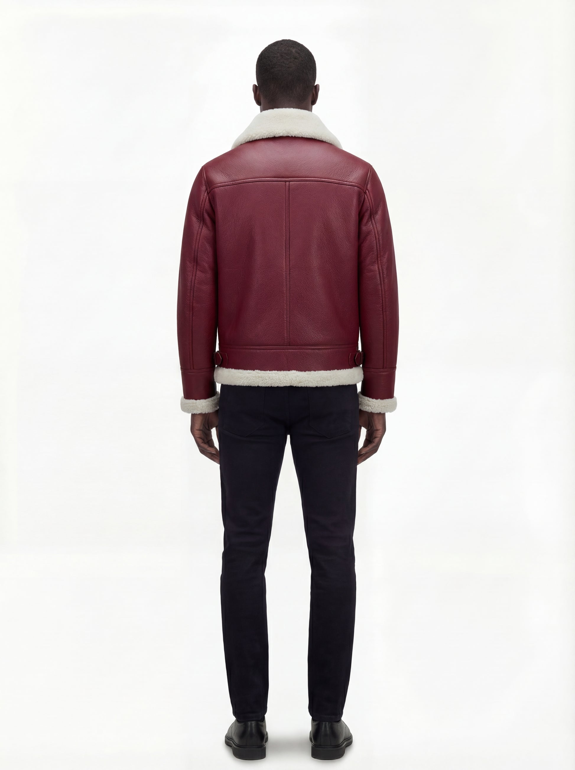 Rear view of male model wearing Maverick Cormac shearling aviator jacket showing structured shoulder fit and shearling-trimmed hem. Maverick Jacket.