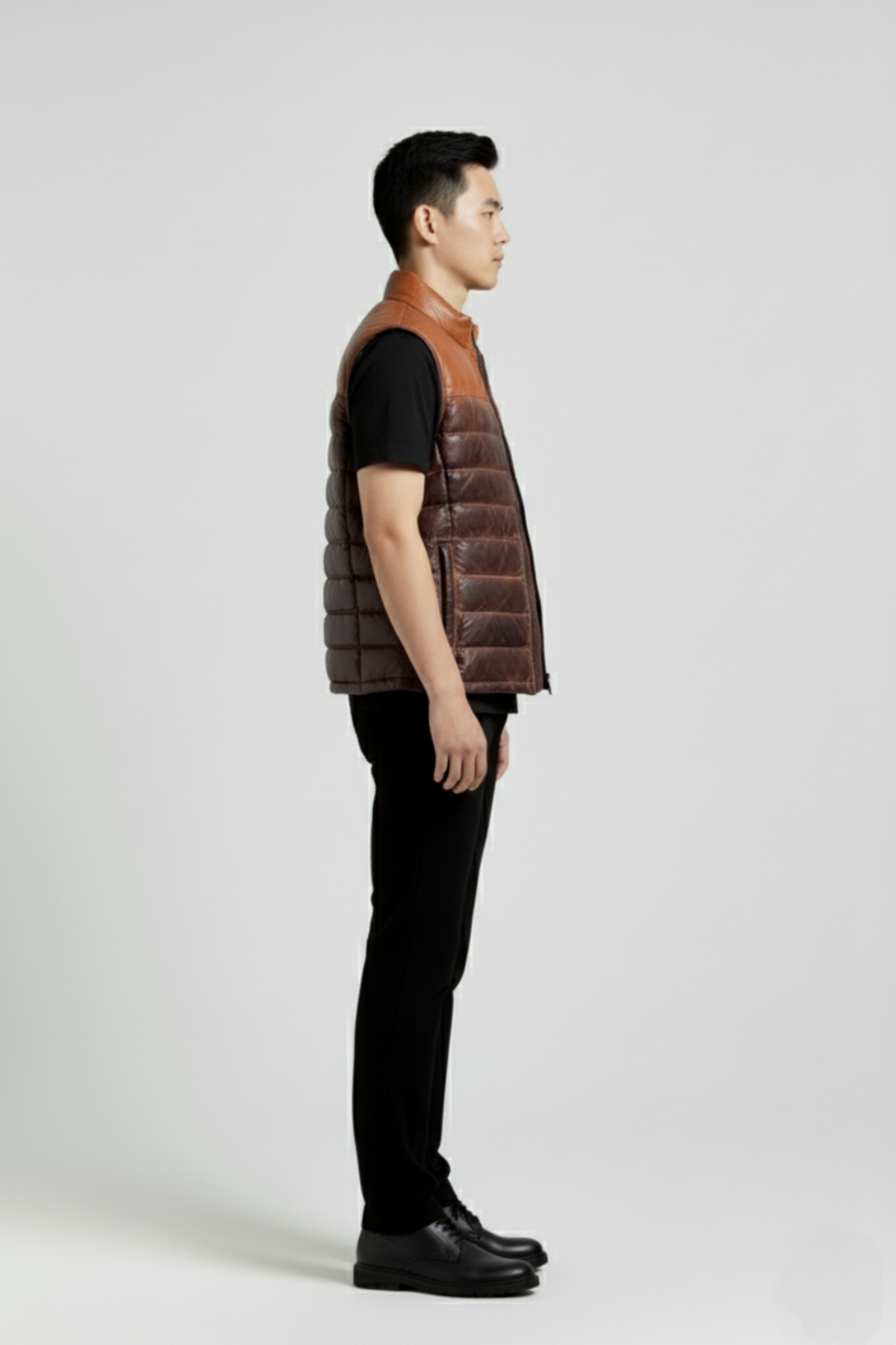Side profile of Maverick Caleb leather puffer vest showing deep armhole cut and insulated puffy silhouette. Maverick Jacket.