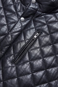 Macro shot of diamond quilted leather texture and silver zipper hardware on vest. The Graham by Maverick Jacket.