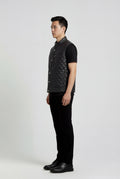 Side profile of Maverick Graham quilted leather vest showing deep armhole cut and puffed quilted silhouette. Maverick Jacket.
