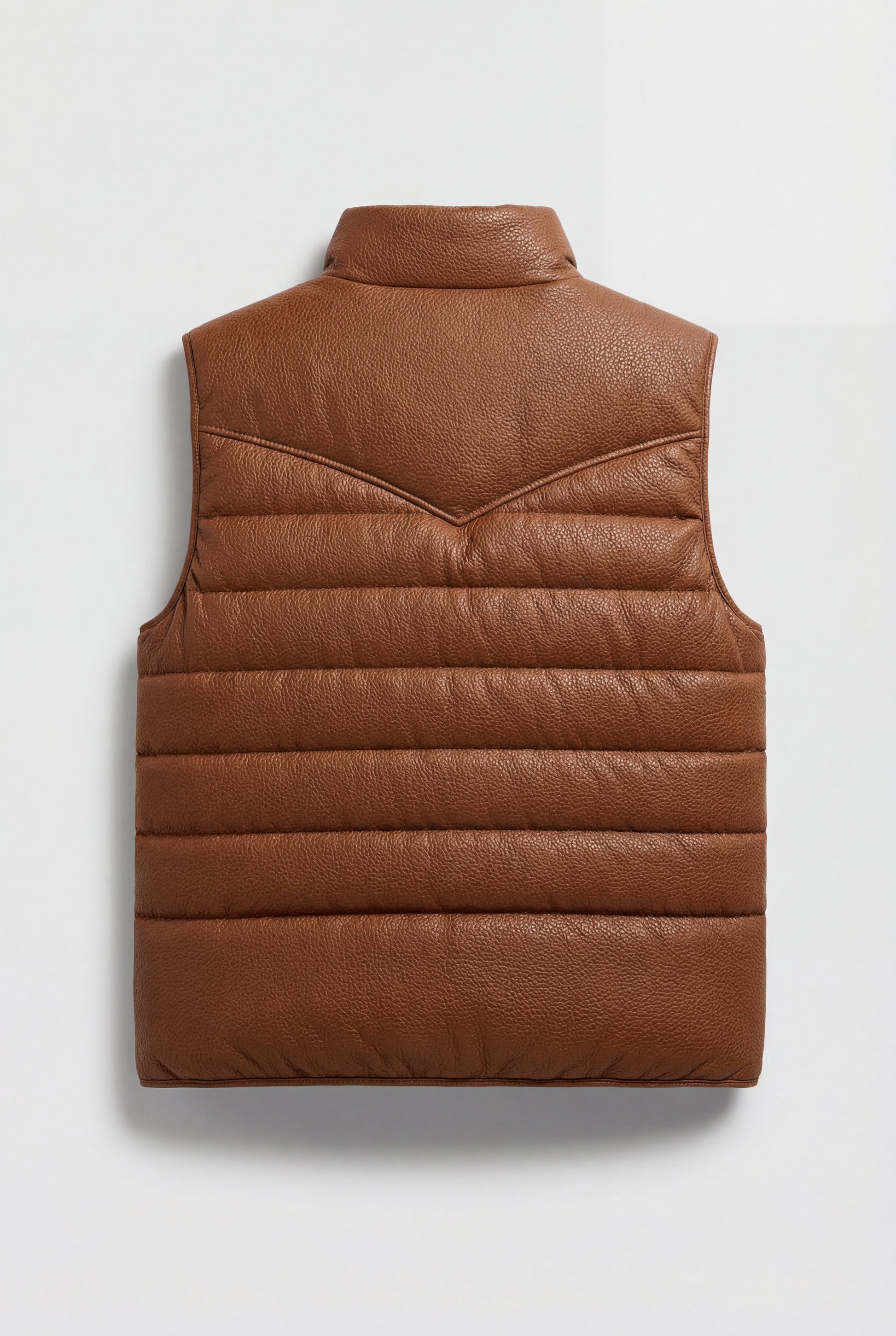 Rear view of tan western puffer vest showing pointed western back yoke and horizontal baffle stitching. The Nash by Maverick Jacket.