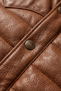 Macro shot of tan suede yoke texture contrasting with nylon puffer body and snap buttons on vest. The Nash by Maverick Jacket.
