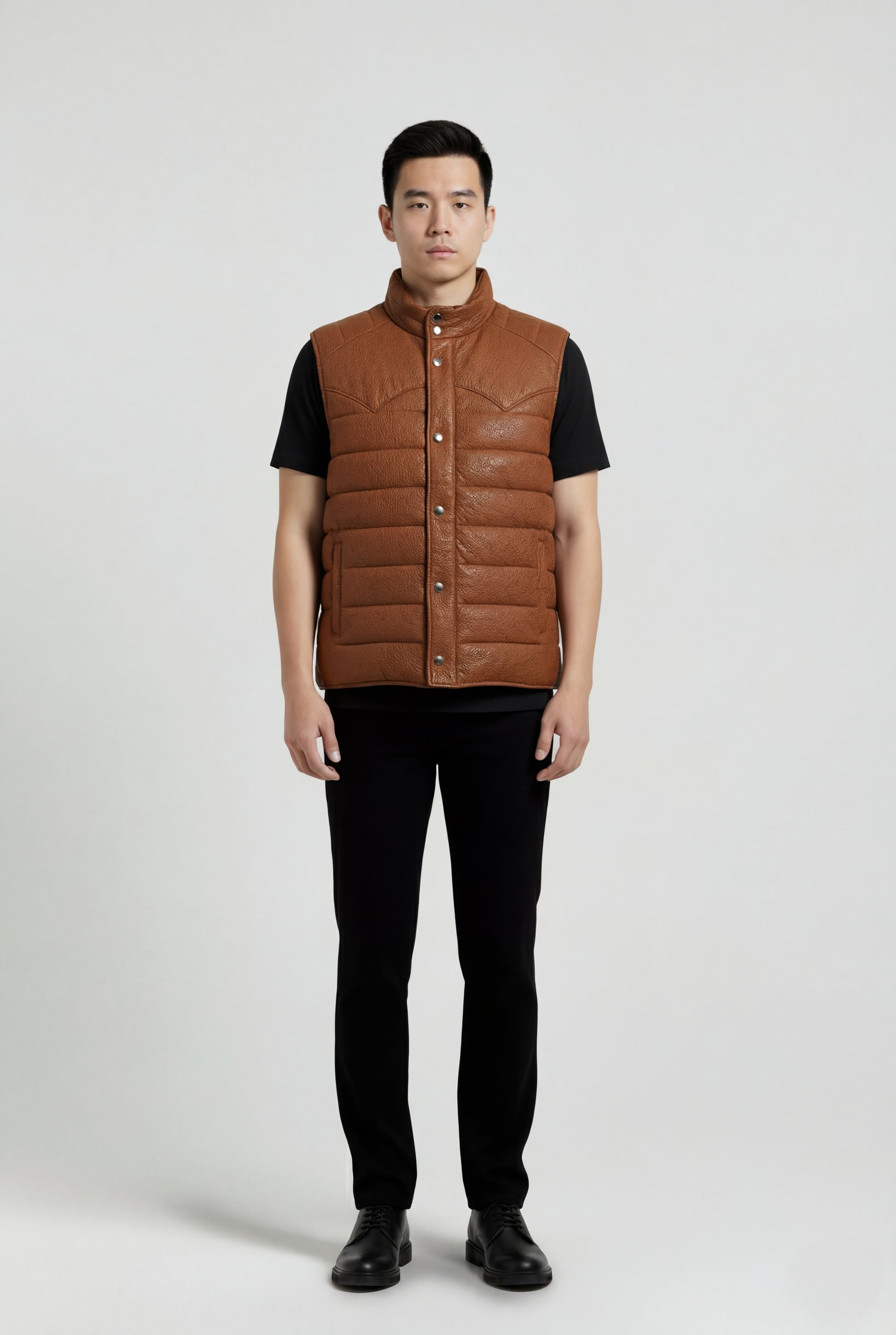 Male model wearing Maverick Nash western puffer vest, regular fit, styled over a plaid flannel shirt with indigo straight-leg denim. Maverick Jacket.