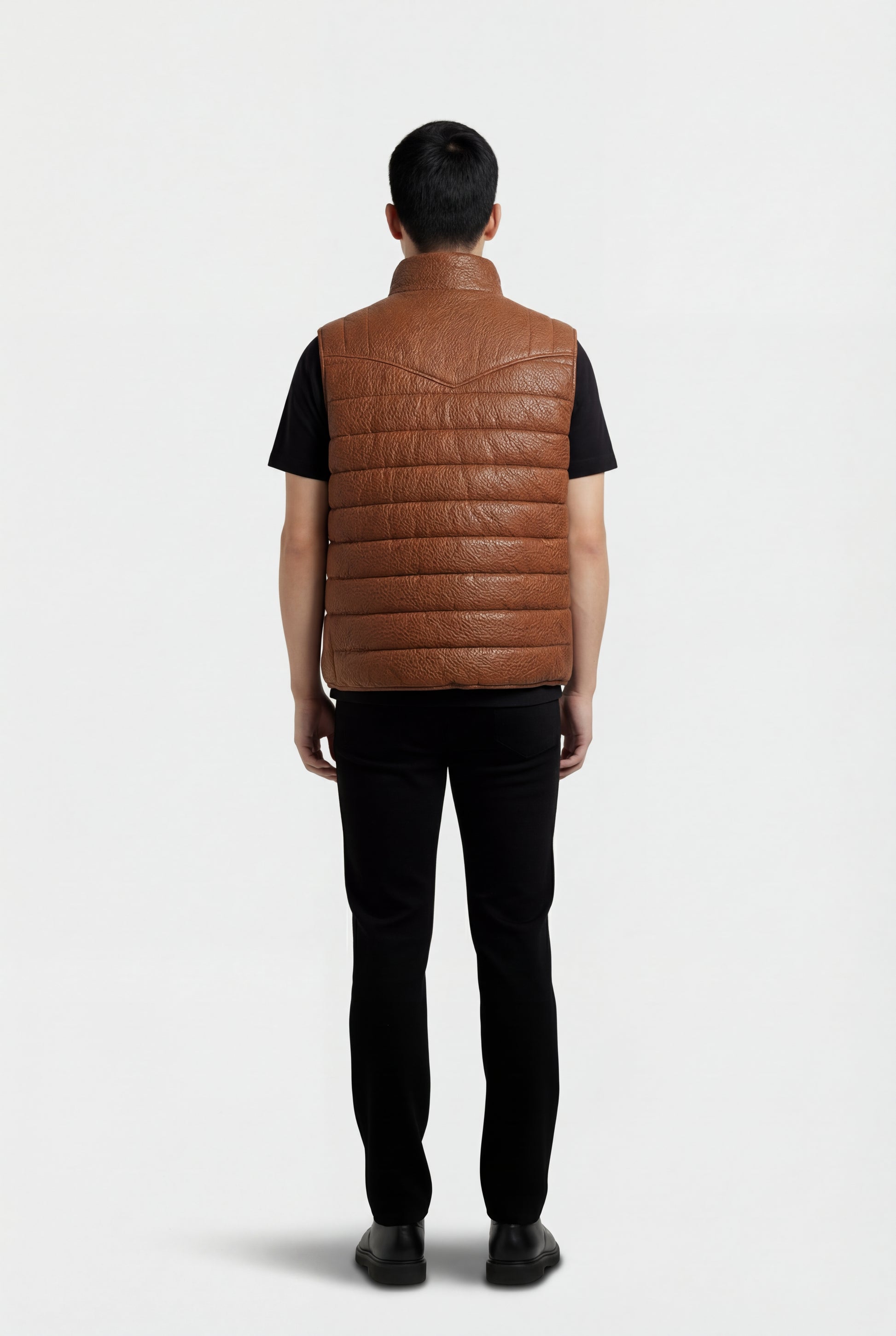 Rear view of male model wearing Maverick Nash western puffer vest showing structured shoulder yoke and insulated back styling. Maverick Jacket.