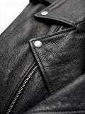 Macro shot of smooth black leather texture and heavy-duty silver zipper hardware on biker vest. The Ryder by Maverick Jacket.