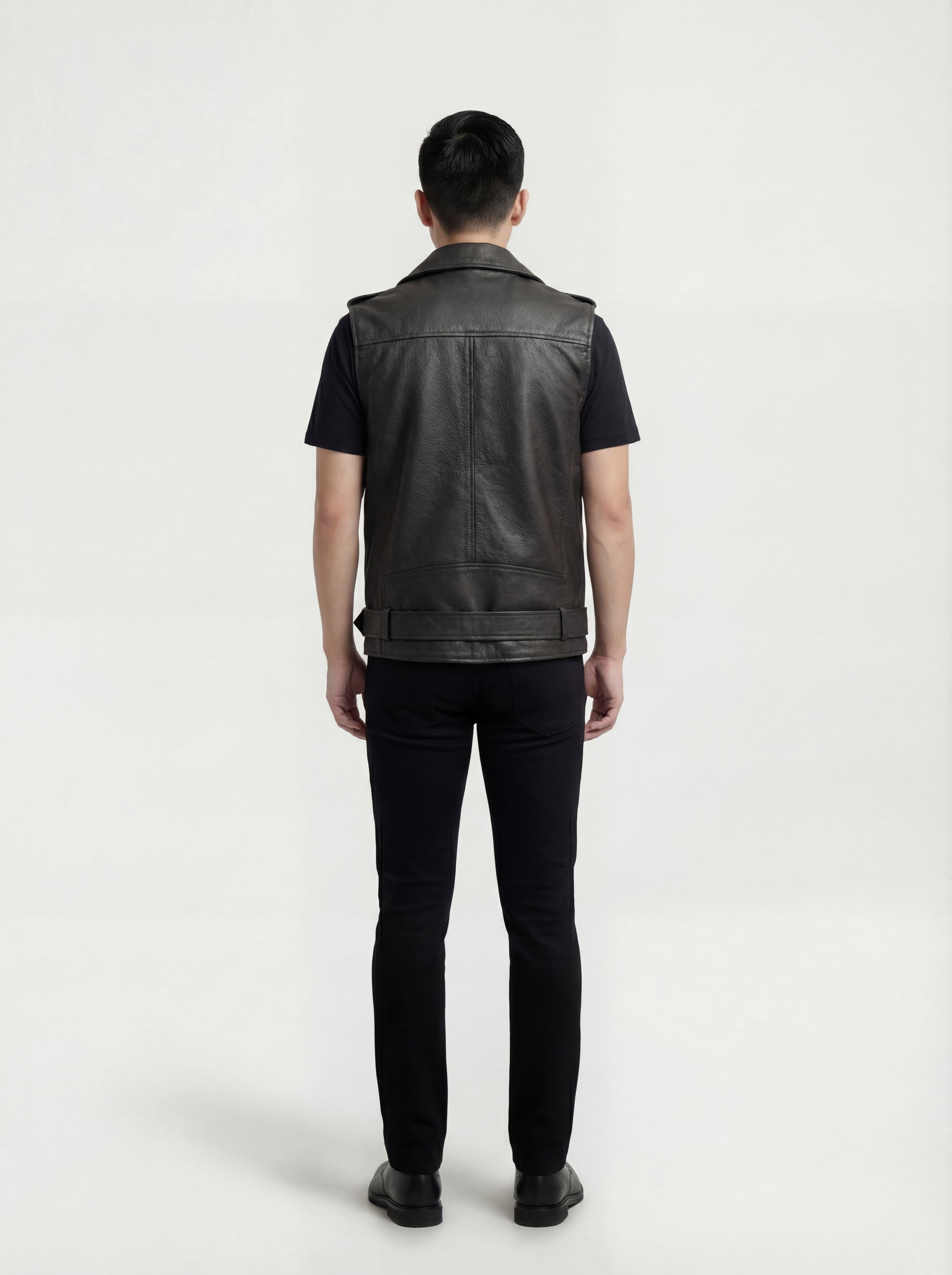 Rear view of male model wearing Maverick Ryder leather biker vest showing broad shoulder fit and clean back yoke styling. Maverick Jacket.