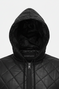 Macro shot of diamond quilted leather texture and silver zipper hardware on hooded vest. The Reid by Maverick Jacket.