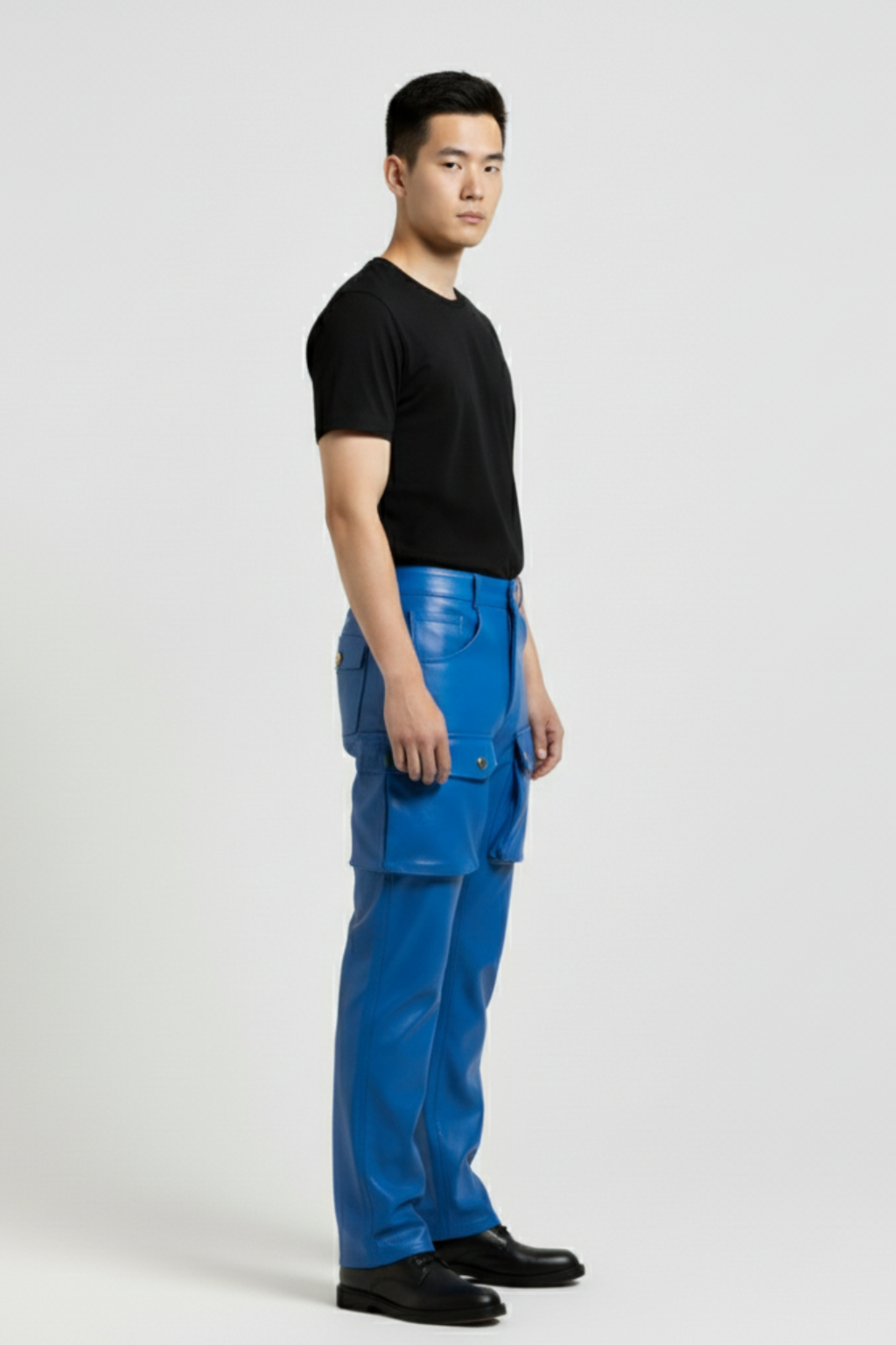 Side profile of Maverick Enzo leather cargo pants showing dimensional cargo pockets and straight leg fit. Maverick Jacket.